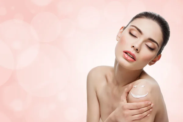 Girl with cream on skin — Stock Photo, Image