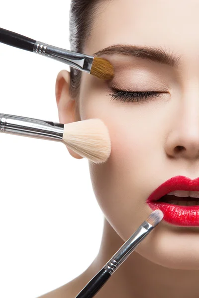 Beautiful girl with makeup brushes — Stock Photo, Image