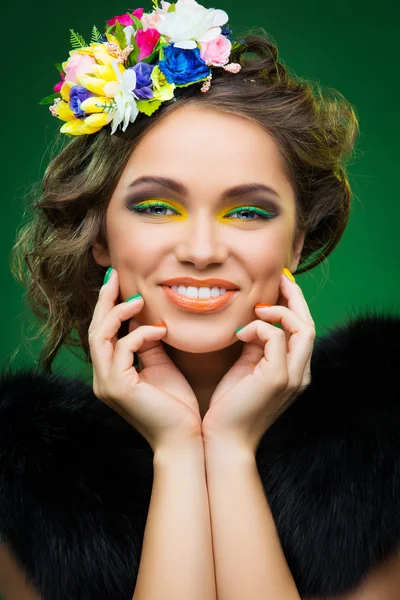Beautiful young woman with flowers on head — Stock Photo, Image
