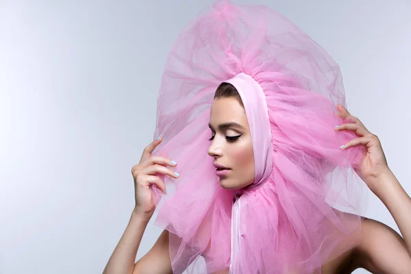 Beautiful girl in fluffy pink headwear — Stock Photo, Image