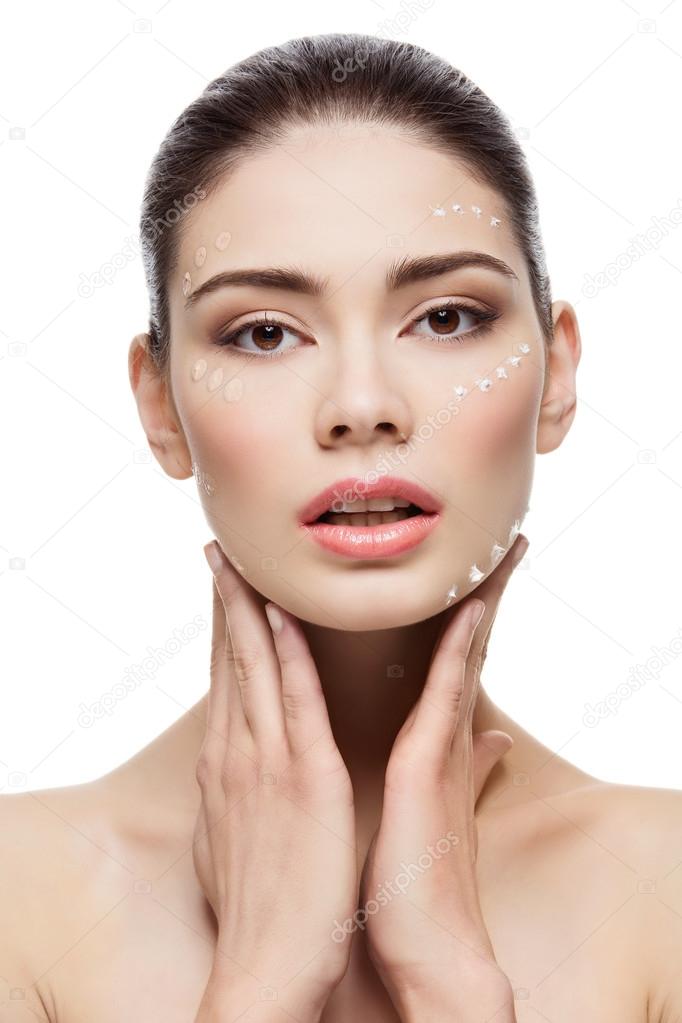 Girl with foundation cream on face