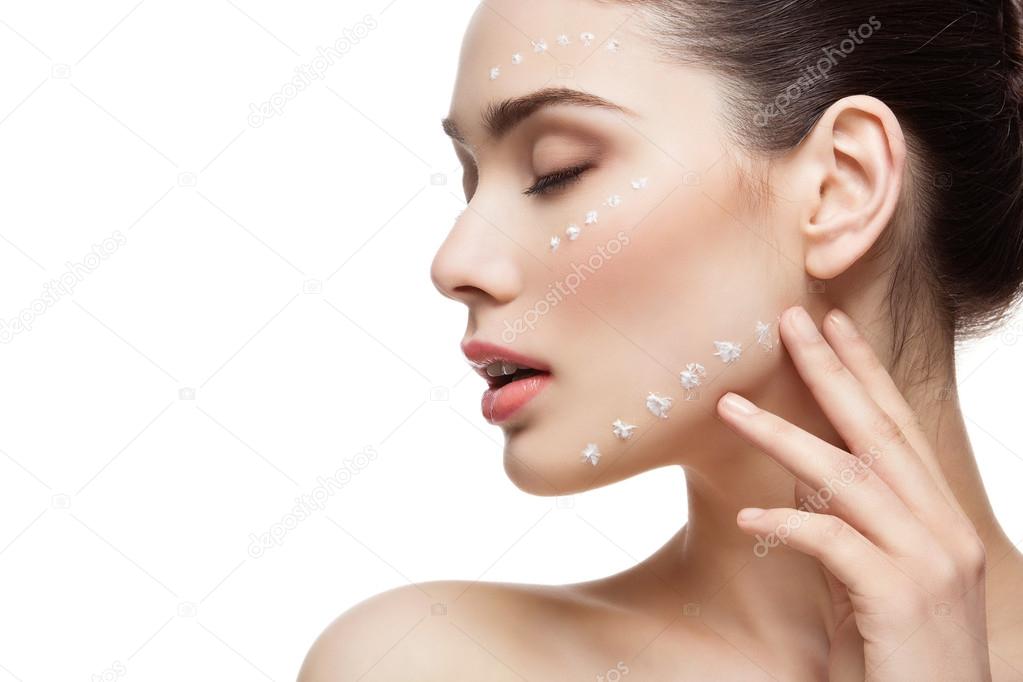 Girl with cream dots on face