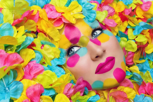 Girl face in flower petals — Stock Photo, Image