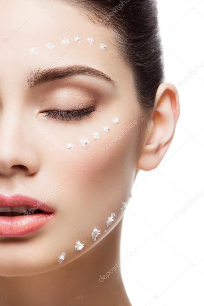 Girl with cream dots on face