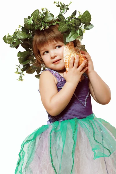 Little girl in a beautiful dress with a wreath on his head, and — Stock Photo, Image