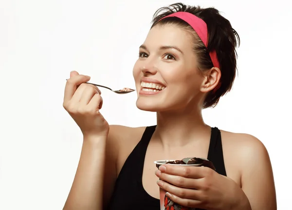 Woman eating a delicious yogurt with chocolate and berries — Stock Photo, Image