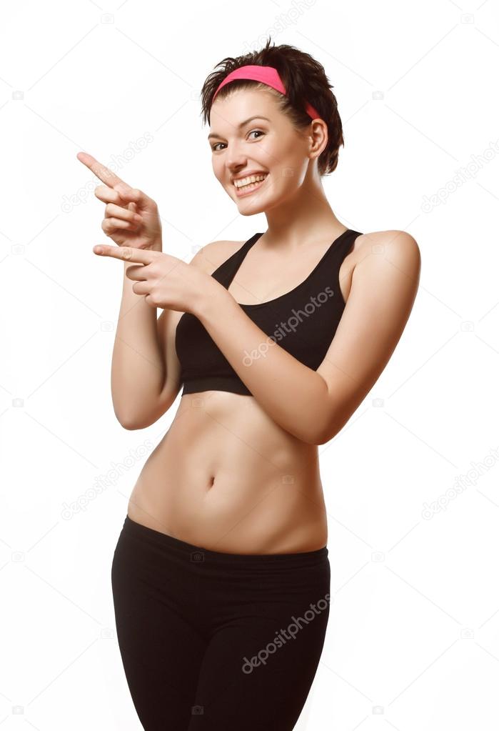 Girl in sportswear clothes indicates the direction. Fitness