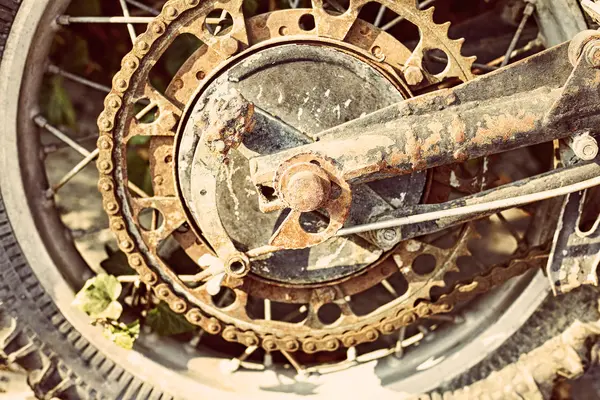 Old dirty motorcycle chain on wheel with rusty metal parts. — Stock Photo, Image