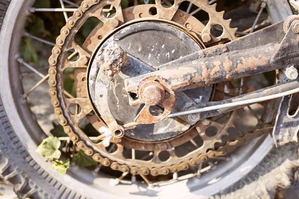 Old dirty motorcycle chain on wheel with rusty metal parts. — Stock Photo, Image
