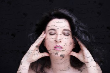 Uzun siyah saçlı, esmer, çekici bir kadın..