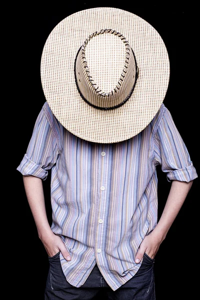 A cowboy is hiding behind his hat — Stock Photo, Image