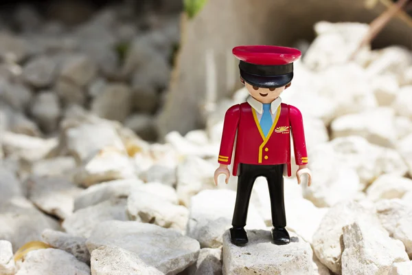 Miniature plastic toy. Man in the form of a passenger plane pilot — Stock Photo, Image