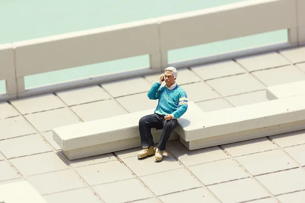 Miniature old man talking on the Cell phone — Stock Photo, Image