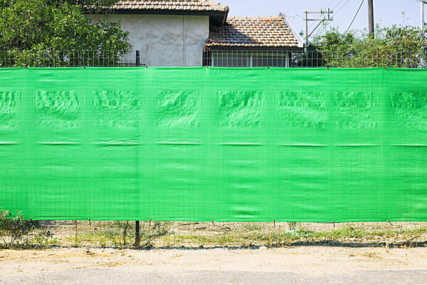 Green fence on the street 