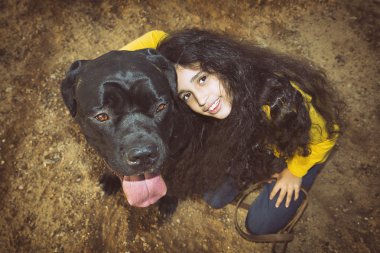 Küçük kız evde beslenen hayvan köpeğiyle oynuyor