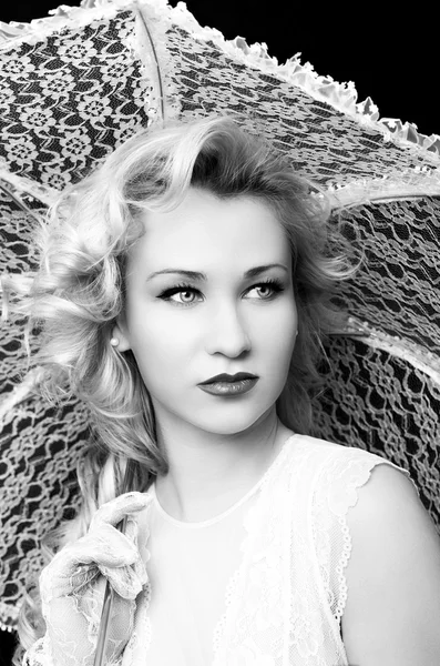 Young gorgeous blonde woman with white umbrella on a dark background — Stock Photo, Image