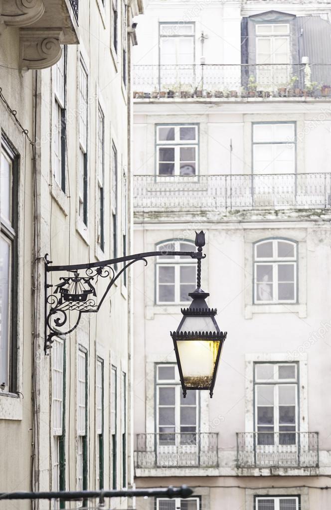 Old street lamp on a classical facade in Lisbon