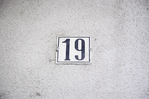 Number nineteen in the wall of a house — Stock Photo, Image