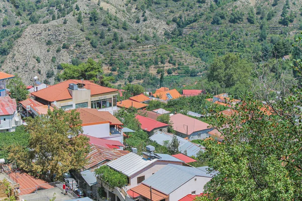 Güneşli bir günde yeşil ağaçların arasında Kykkos manastırının çatıları — Stok fotoğraf