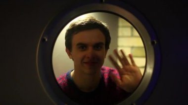 Adam yuvarlak penceresinde arama yapar