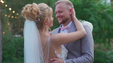 Bride holds hand across grooms face