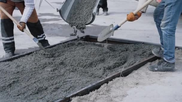 Primo piano colpo di colata di calcestruzzo su barre metalliche di rinforzo di una lastra sul cantiere industriale. Creazione di lastre di cemento armato in produzione — Video Stock