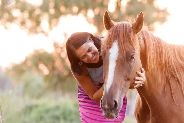 Pretty women is hugging and kissing her handsome horse — Stock Photo, Image