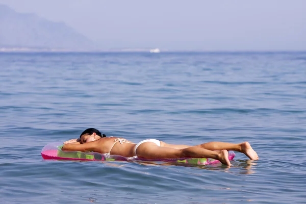 Young woman on air mattress — Stock Photo, Image