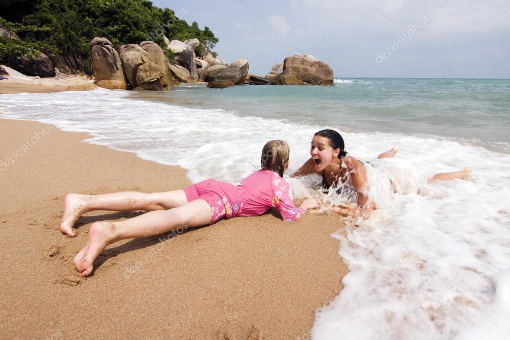 Mother and daughter having fun in the ocean