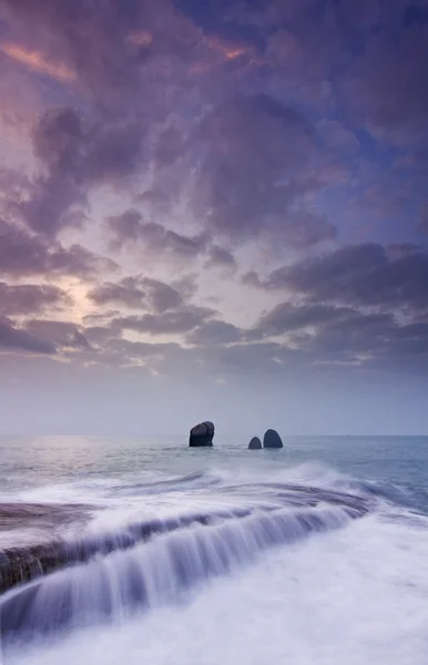 Sunrise landscape of ocean with waves clouds and rocks — Stock Photo, Image
