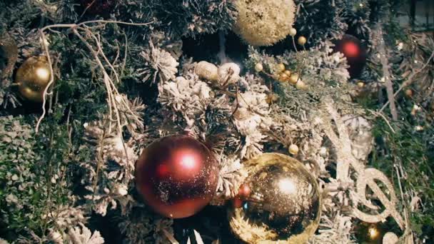 Spruce branch covered by beautiful decorations and colored lights — Stock Video