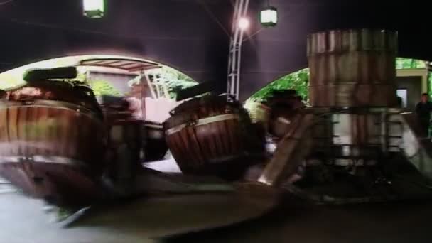 Holiday park. Germany. in may of 2014 . people ride on the spinning barrels — Stock Video