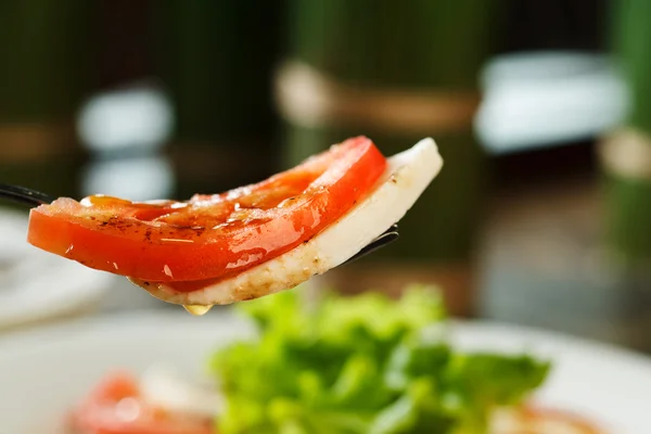 Caprese salad on fork — Stock Photo, Image