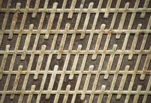 Rusty iron lid with a pattern — Stock Photo, Image