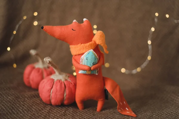 Toy fox and handmade pumpkins. House decor, cozy handmade toys. Thankgiving or Christmas gift concept