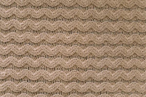 Knitting pattern of wool. Knitting. Texture of knitted woolen fabric for wallpaper and an abstract background — Stock Photo, Image