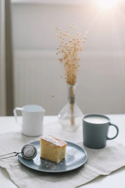 Кусок домашнего торта с чашкой капучино на столе и льняной скатертью. Утренний завтрак Вид сверху, плоский, копировальное пространство — стоковое фото