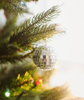 Arka planda çelenk olan bir Noel ağacında Noel balosu. Yeni yıl arkaplanı