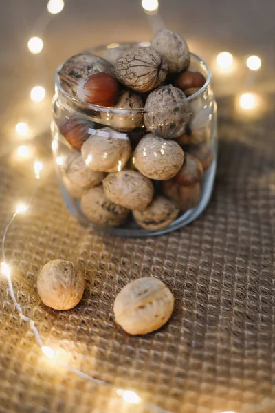 Mix of nuts in a jar on dark background. Walnuts and pine nuts. Top view. Copy space. Superfood, vegan, vegetarian food concept. Macro of walnut texture. selective focus. Healthy snack. — Stock Photo, Image
