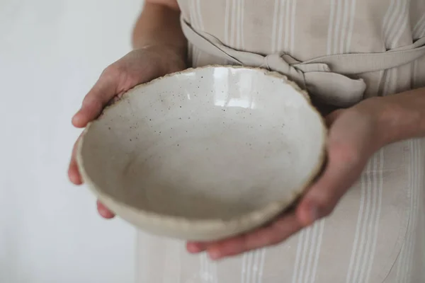 Hands holding ceramic bowl isolated on white background. Handmade ceramic tableware and pottery — Stock Photo, Image
