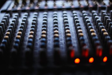 Professional audio studio sound mixer console board panel with recording , faders and adjusting knobs,TV equipment.