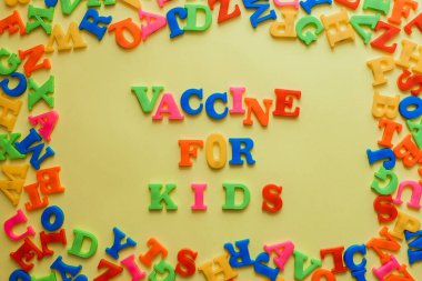 the word vaccine on a yellow background. Vaccination concept