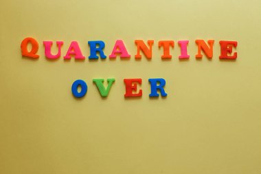The concept of ending the quarantine. the word quarantine on a yellow background