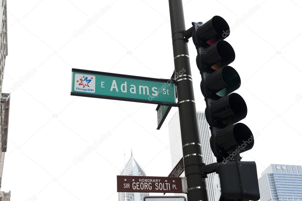 Street sign at Adams St and a traffic signal