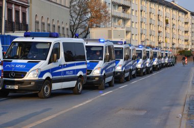 FRANKFURT, GERMANY - MARCH 18, 2015: Police cars, Demonstration  clipart