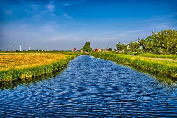 Ayna reflec ile bir kanal ve çim alanlar ile Hollandalı peyzaj — Stok fotoğraf