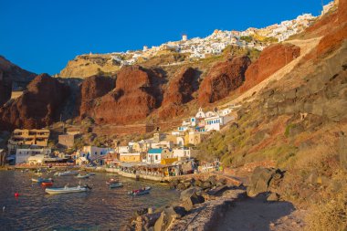 SANTORINI, GREECE - OCTOBER 5, 2015: The Amoudi harbor of Oia in sunset light.