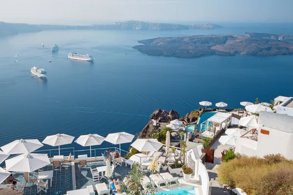 Santorini - The outlook over the luxury resort in Imerovigili to caldera with the cruises and Na Kameni island. — стокове фото