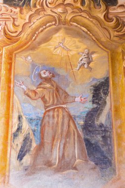 BANSKA STIAVNICA, SLOVAKIA - FEBRUARY 20, 2015: The fresco of the Stigmatization of St. Francis of Assisi in the lower church of baroque calvary by Anton Schmidt (1745) in the Chapel of Sacred heart. clipart
