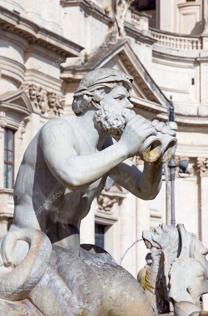 Rome - The detail of fountain Fontana del Moro by Giacomo della Porta (1575) on Piazza on Navona and baroque Santa Agnese in Agone church.